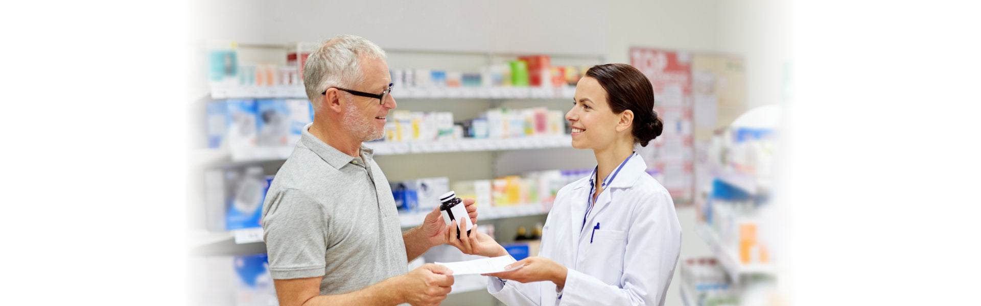 pharmacist giving senior man medication