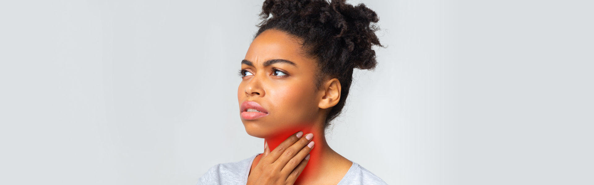 woman holding her throat